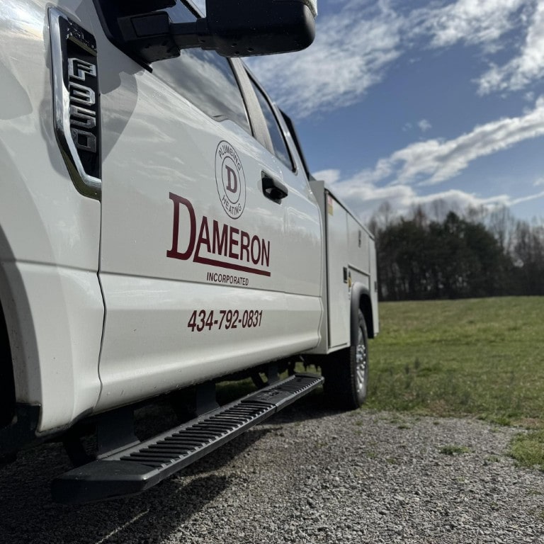 White Dameron Plumbing Incorporated service truck parked on site ready for residential and commercial calls.